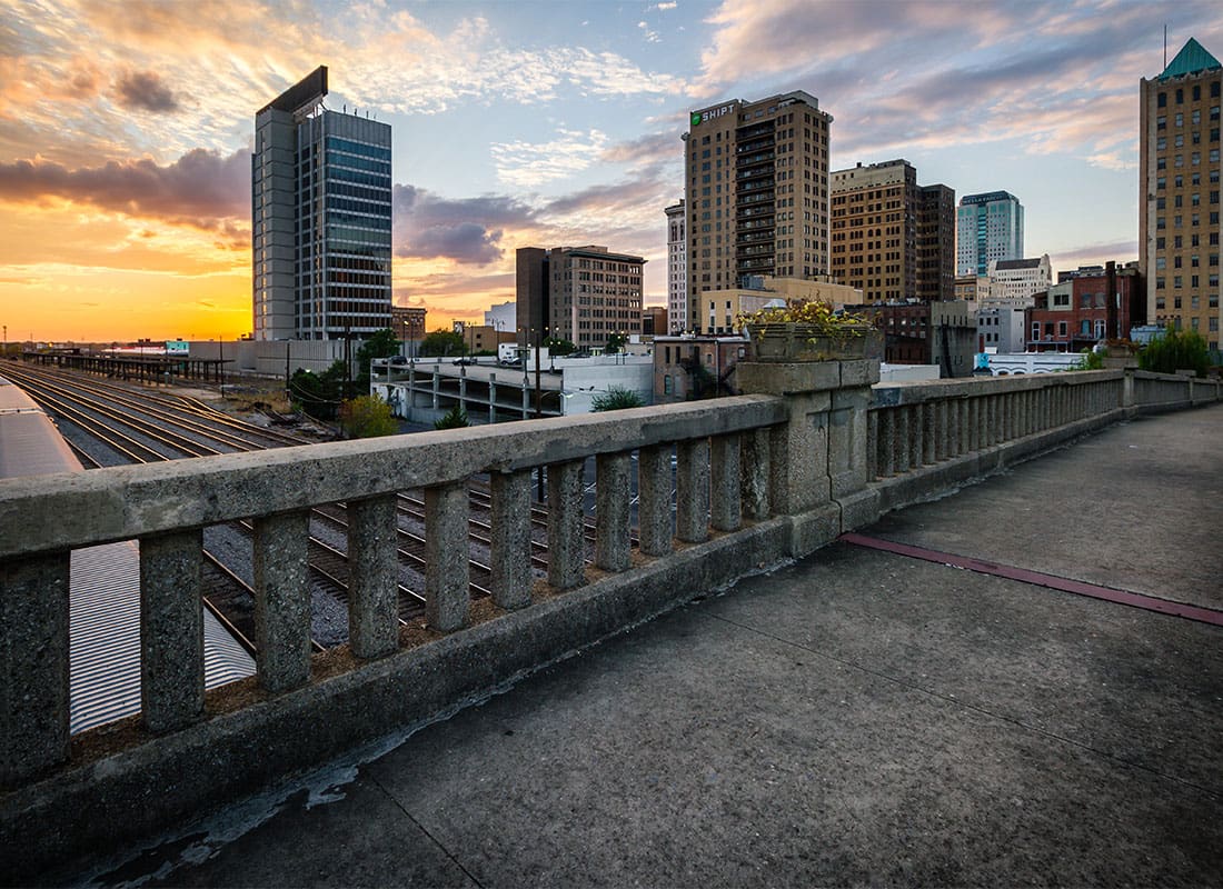 Birmingham, AL - View of Commercial Buildings in Downtown Birmingham Alabama Against a Colorful Sunset Sky